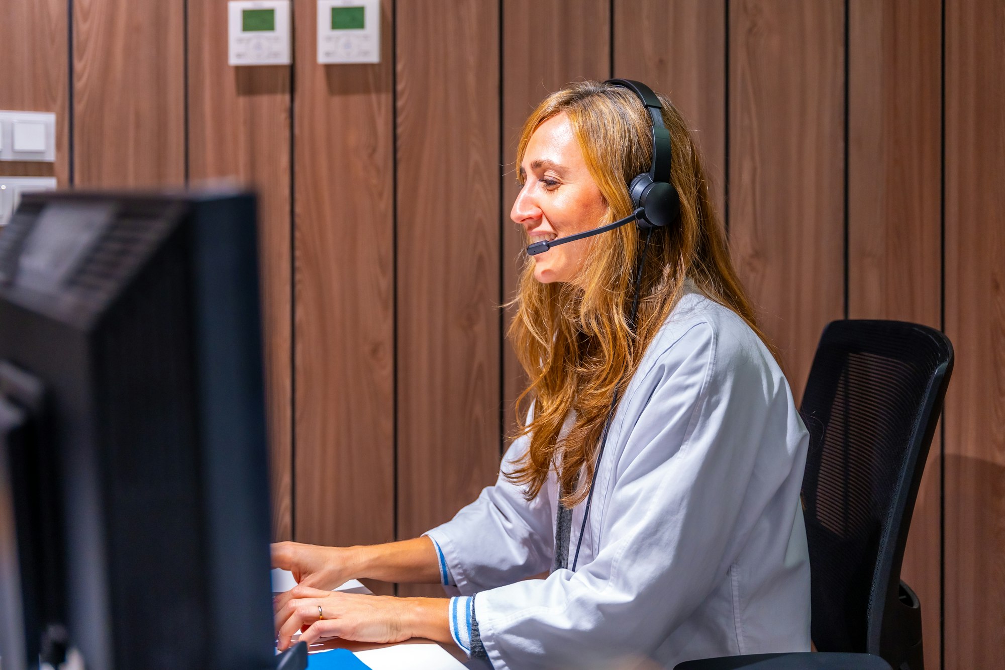 Hospital nurse receptionist talking to patient at registration counter